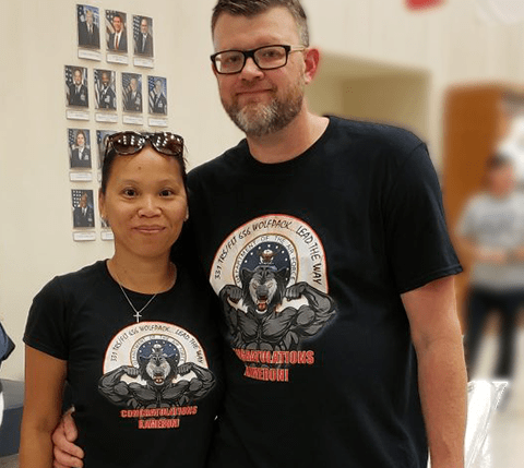 man and woman wearing air force logo on black tshirt